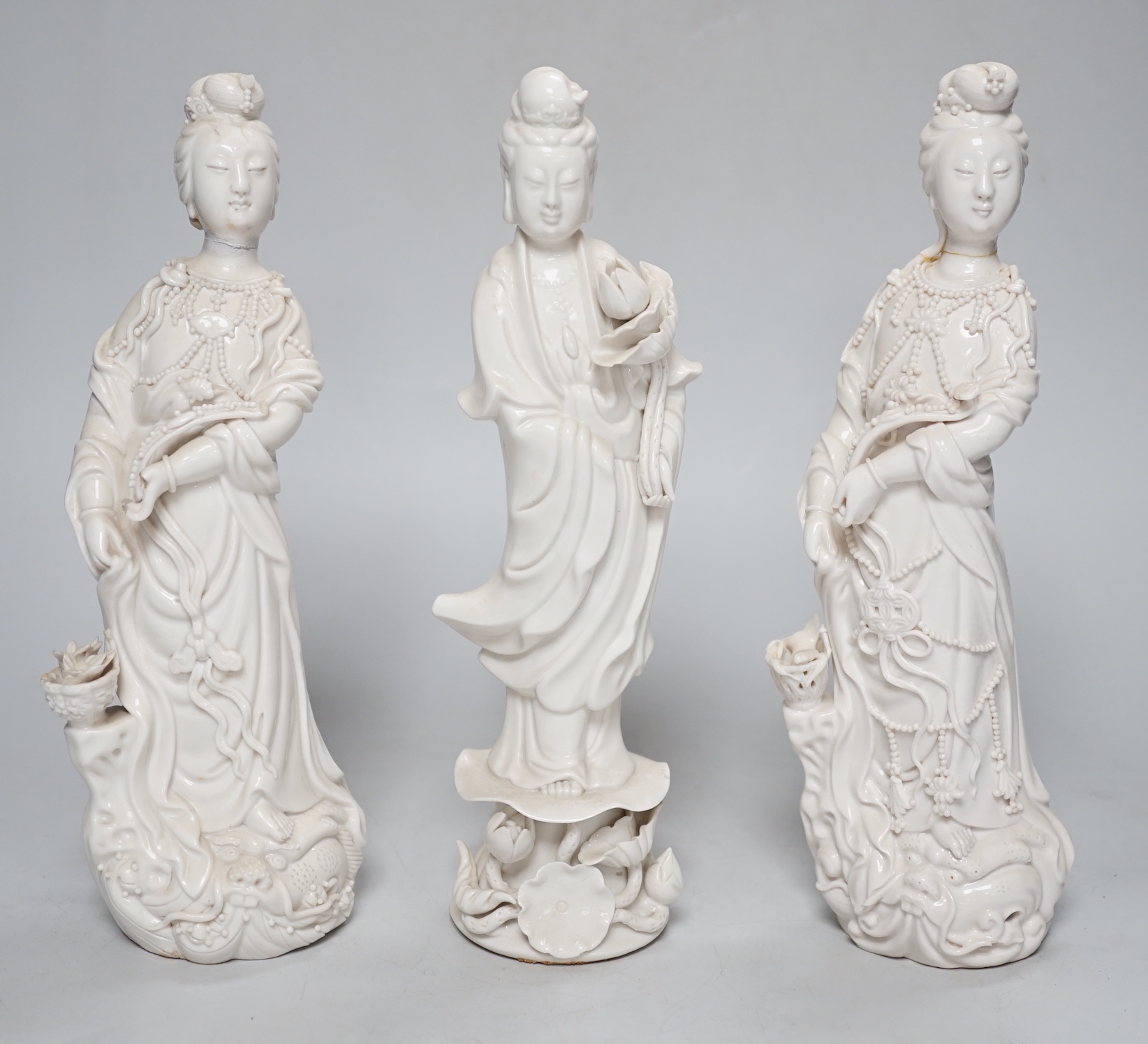 Three Chinese blanc de chine figures of Guanyin, 25cm
